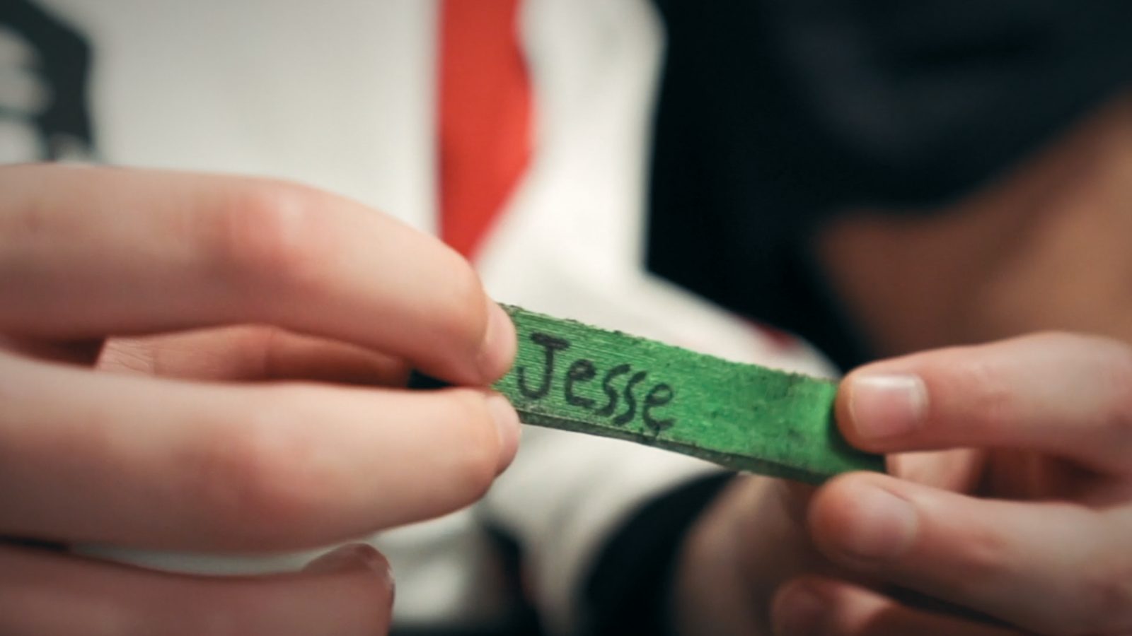 A small strip of green tape with the name Jesse written on it